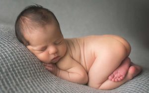 Baby Boy Newborn Posed on Grey Fabric