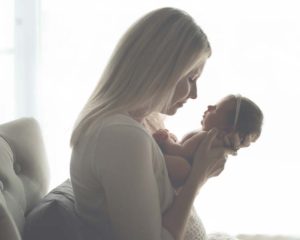 Mom with Newborn Baby Boy Angelically backlit. Bethesda Maryland Newborn Photographer