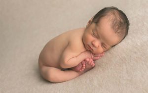 Newborn Boy Posed Sleeping on Tan Fabric Bethesda Newborn Photographer